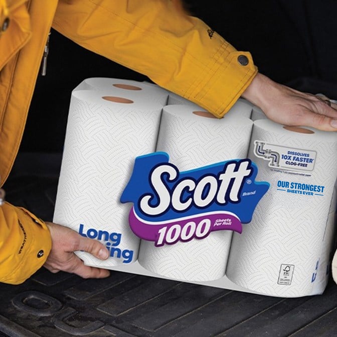 A person putting Scott®1000 toilet paper in a car