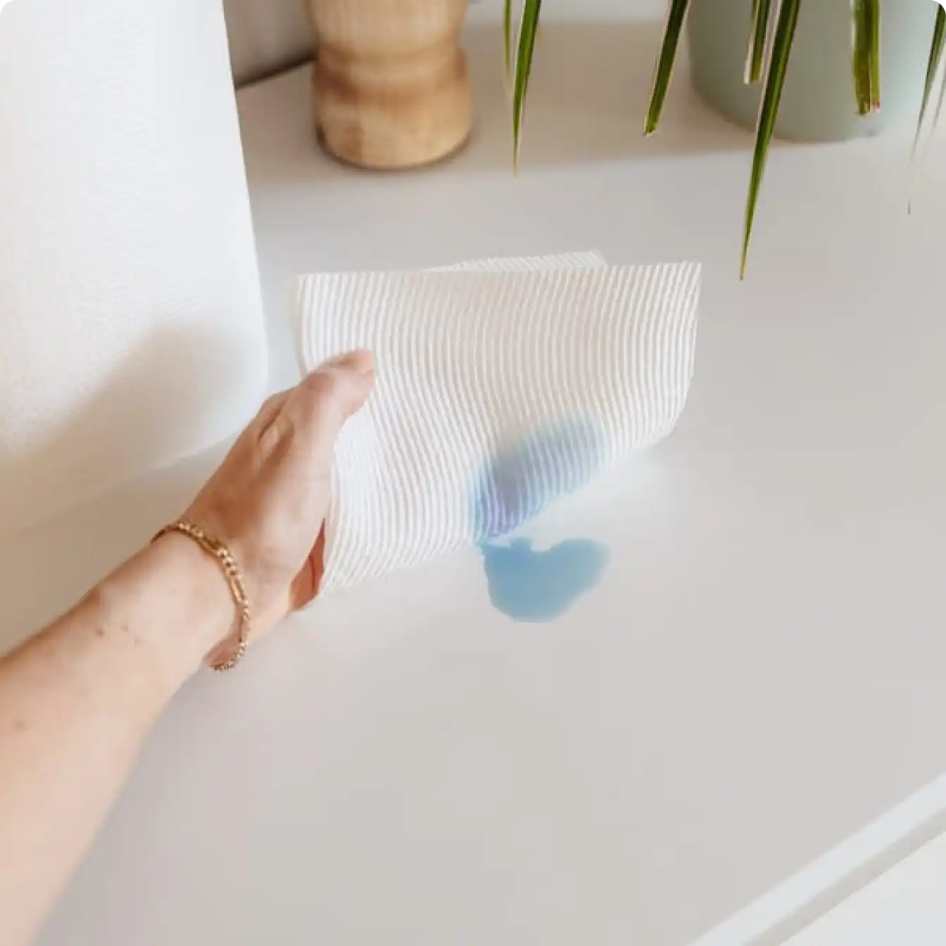 Person using Scott® Paper Towel to clean mess